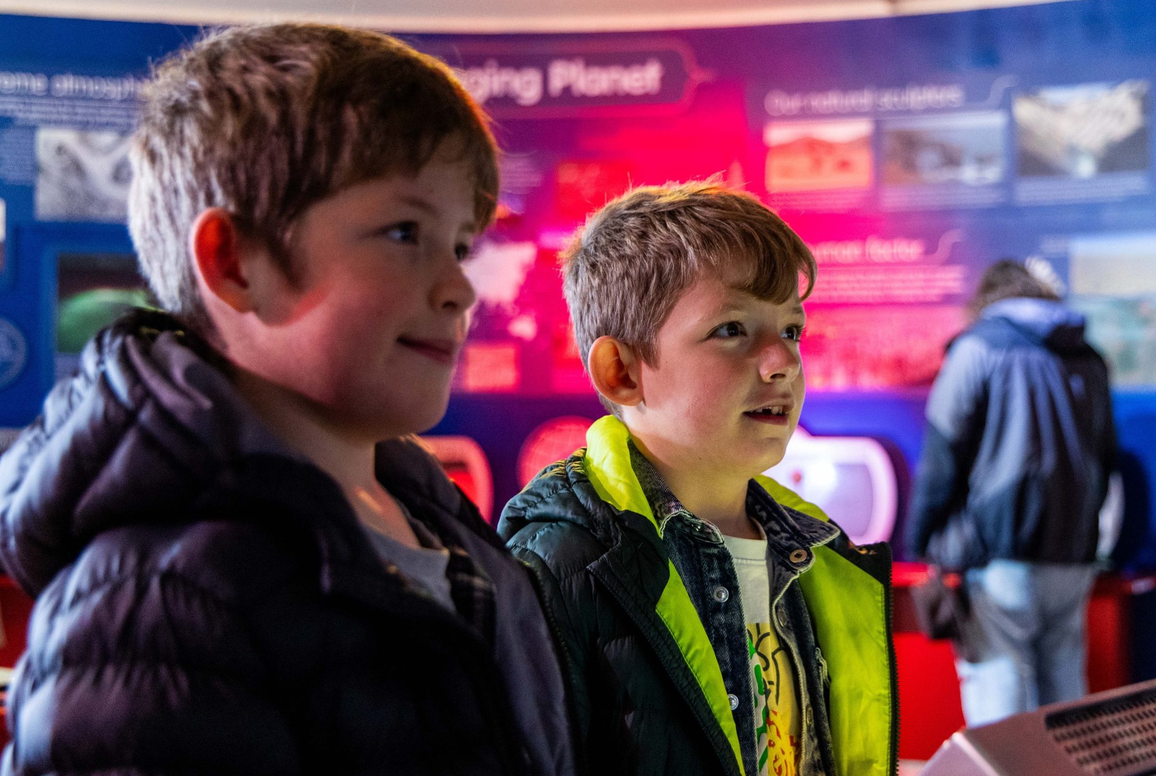school children looking at interactive science exhibits