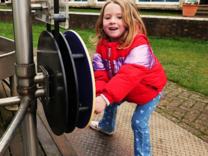 child playing with water exhibit at the observatory science centre