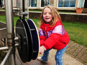 child playing with water exhibit at the observatory science centre