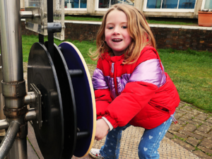 child playing with water exhibit at the observatory science centre